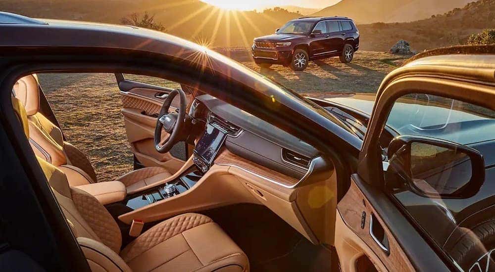 The brown interior of a 2022 Jeep Grand Cherokee is shown from the passenger side.