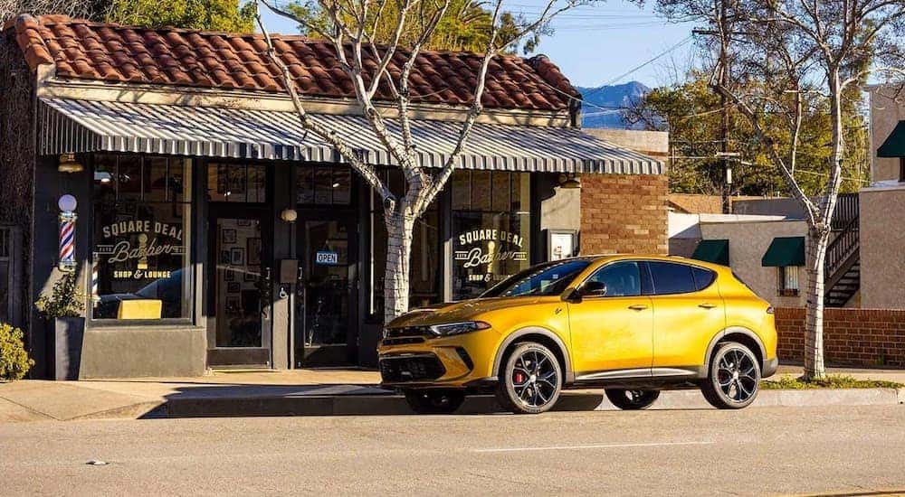 A yellow 2024 Dodge Hornet is shown parked on the side of a road.