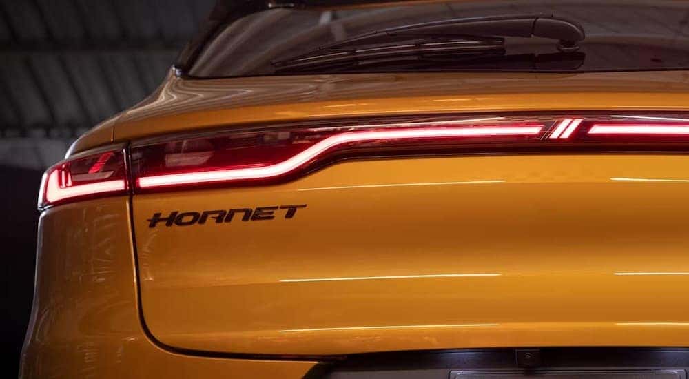 The rear of a yellow 2024 Dodge Hornet is shown in close-up after leaving a dealer that has a Dodge Hornet for sale.