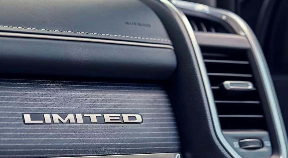 A close-up of the Limited badge on the dash of a 2024 Ram 1500 Limited is shown.
