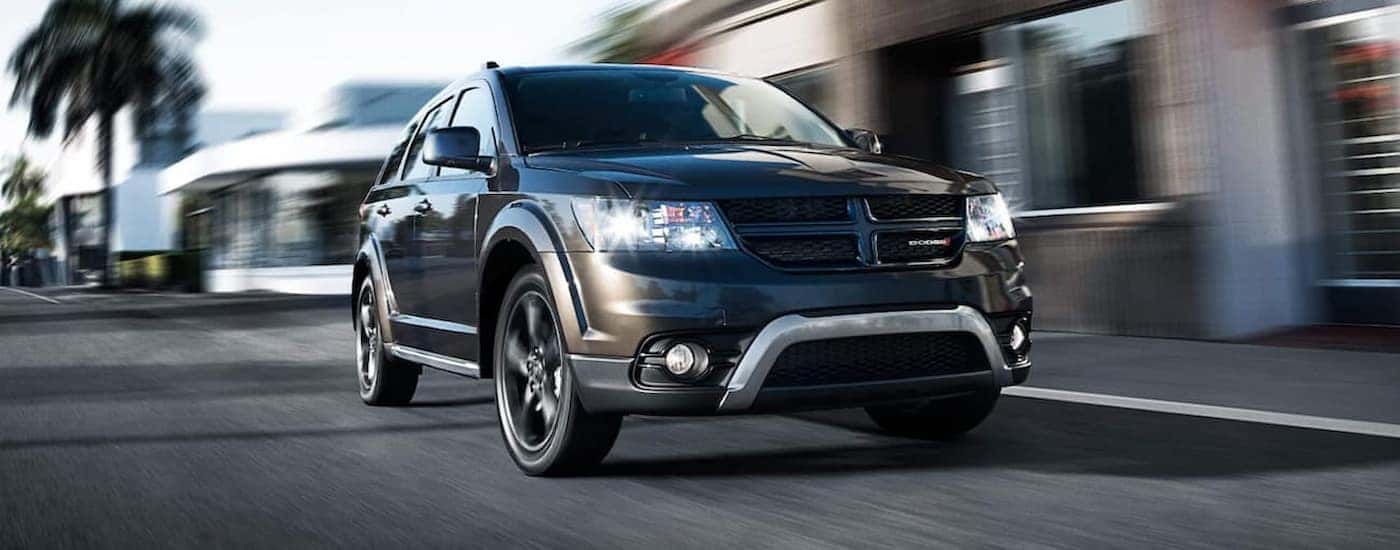 A black 2020 Dodge Journey is shown driving on a city street.