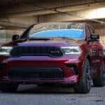 A dark red 2024 Dodge Durango SRT parked in a concrete structure.
