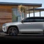 A white 2024 Jeep Wagoneer S is shown parked near a house.