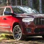 A red 2025 Ram 1500 Tungsten is shown from the front at an angle.