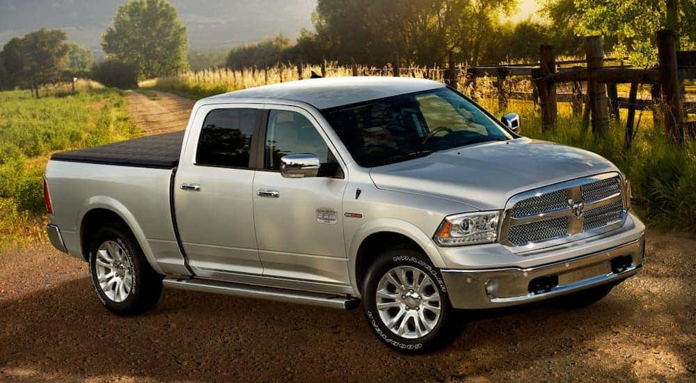 A silver 2017 Ram 1500 is shown parked on a dirt road.