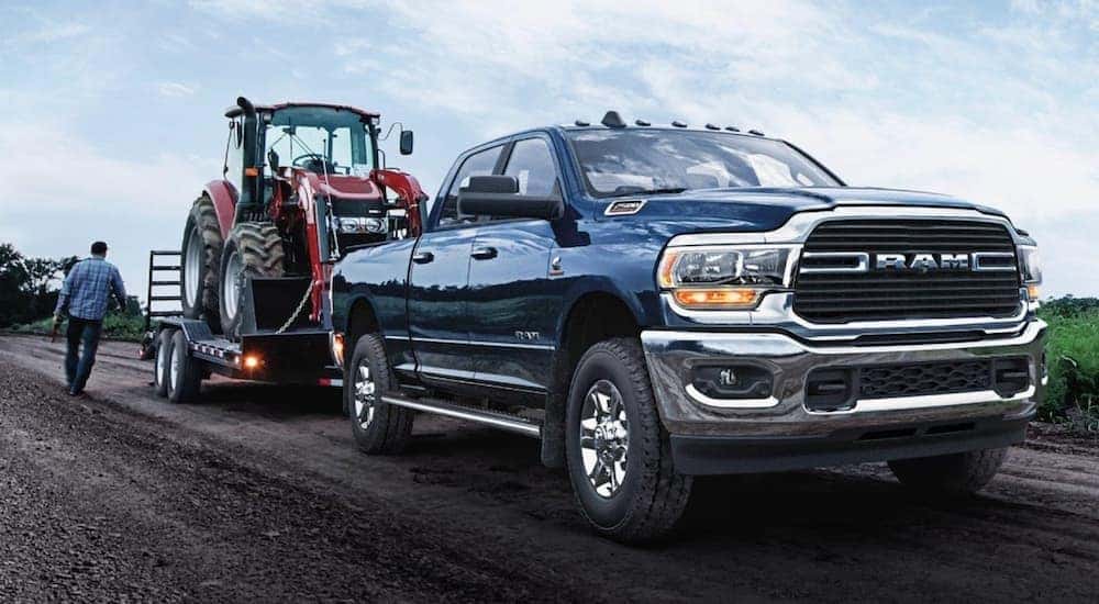 A blue 2020 Ram 2500 is shown towing a trailer.