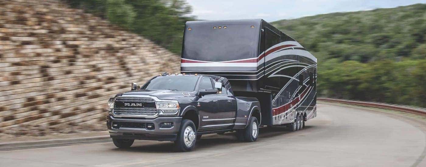 A gray 2020 Ram 3500 is shown towing a trailer.