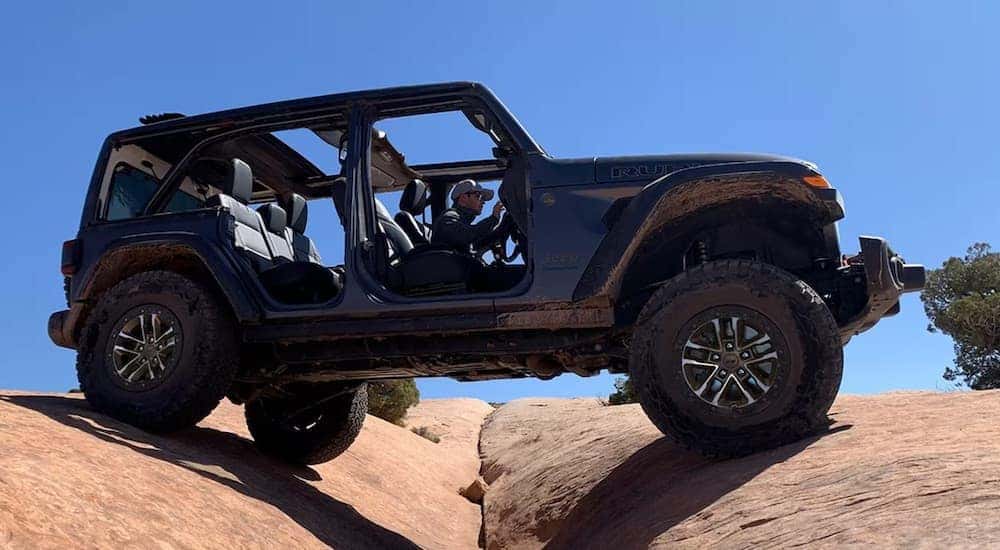 A grey 2023 Jeep Wrangler Rubicon is shown from the side.