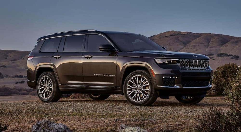A grey 2023 Jeep Grand Cherokee parked off-road and angled right.