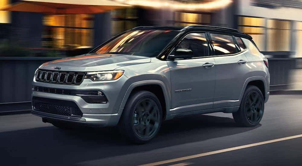 A silver 2025 Jeep Compass is shown from the front at an angle.