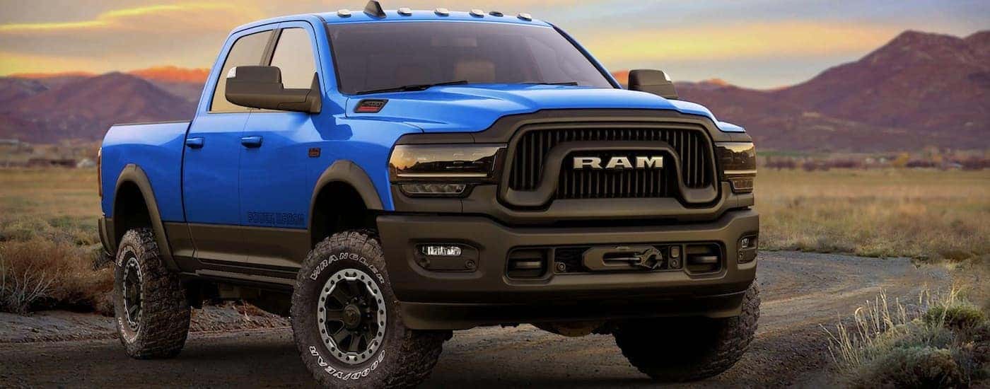 A blue 2022 Ram 2500 Power Wagon is shown from the front after leaving a dealer with used trucks for sale.