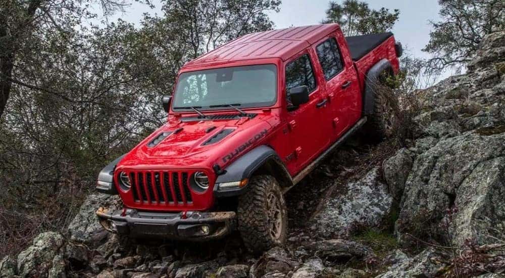 A red 2022 Jeep Gladiator Rubicon is shown off-road.