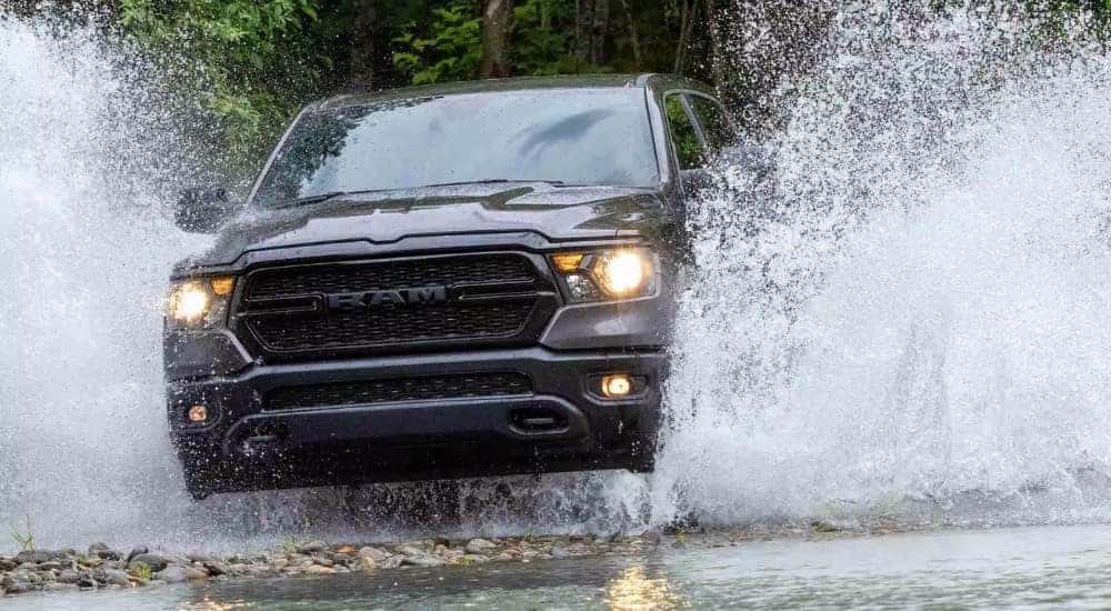 A grey 2023 Ram 1500 Warlock Edition is shown going to look at used trucks for sale.