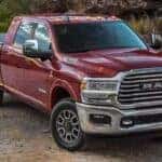 A red 2024 Ram 2500 is shown parked off-road.