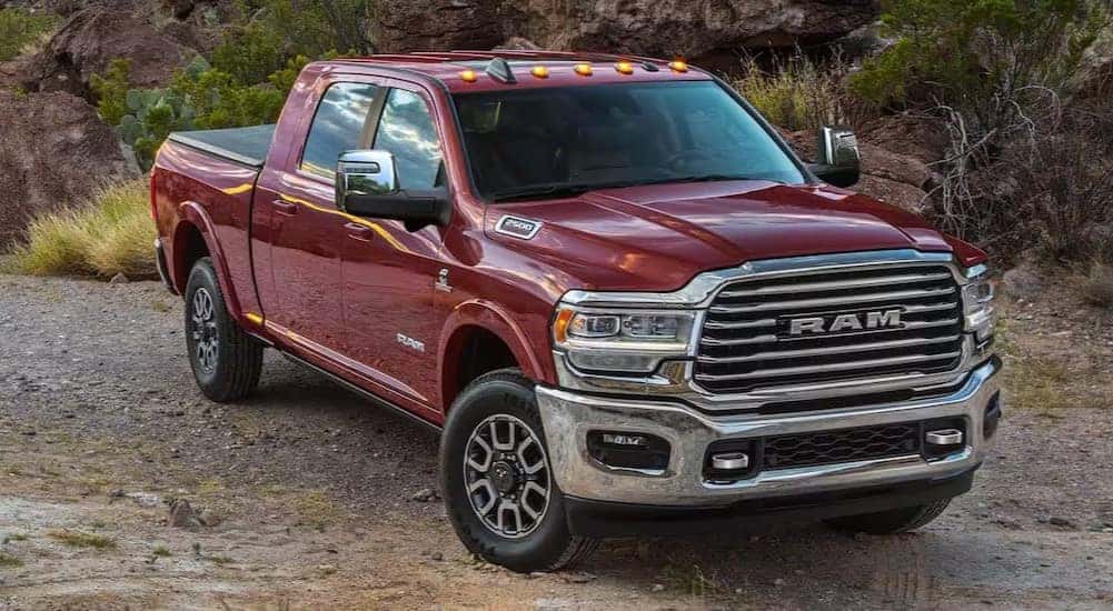 A red 2024 Ram 2500 is shown parked off-road.