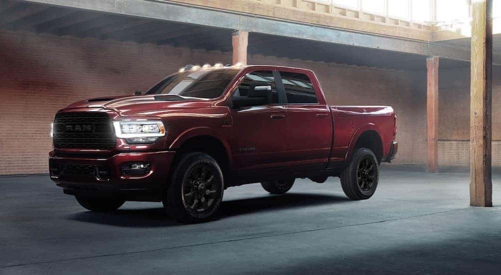 A red 2024 Ram 2500 is shown parked near a brick wall.