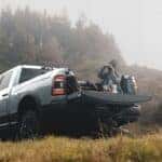 A silver 2024 Ram 2500 for sale is shown parked near photographers.