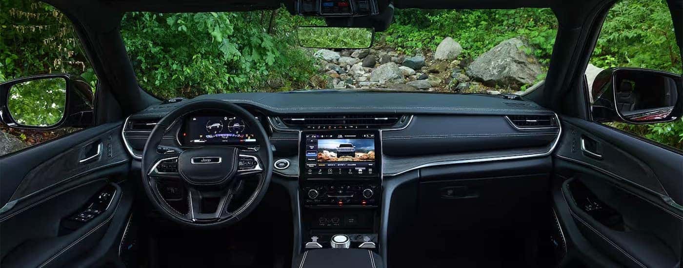 A black 2024 Jeep Grand Cherokee is shown from above the center console.