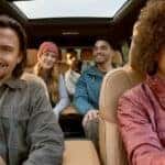 People are shown sitting in the brown interior of a 2025 Jeep Grand Cherokee L.