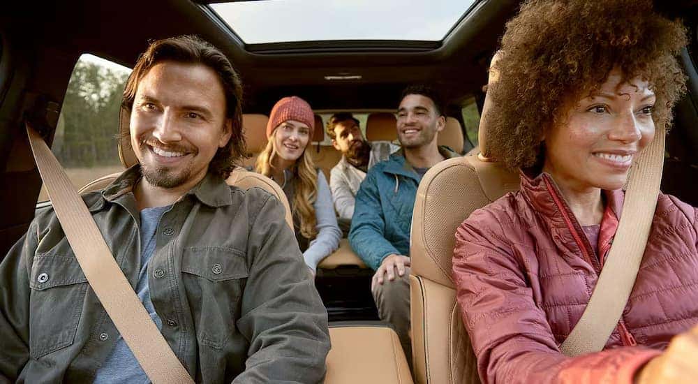 A group of friends are driving a 2025  Jeep Grand Cherokee L for sale in Florence.