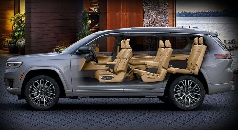 A grey x-ray view of a 2025 Jeep Grand Cherokee-L in a driveway.