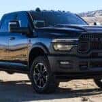 A black 2025 Ram 1500 parked in a desert.