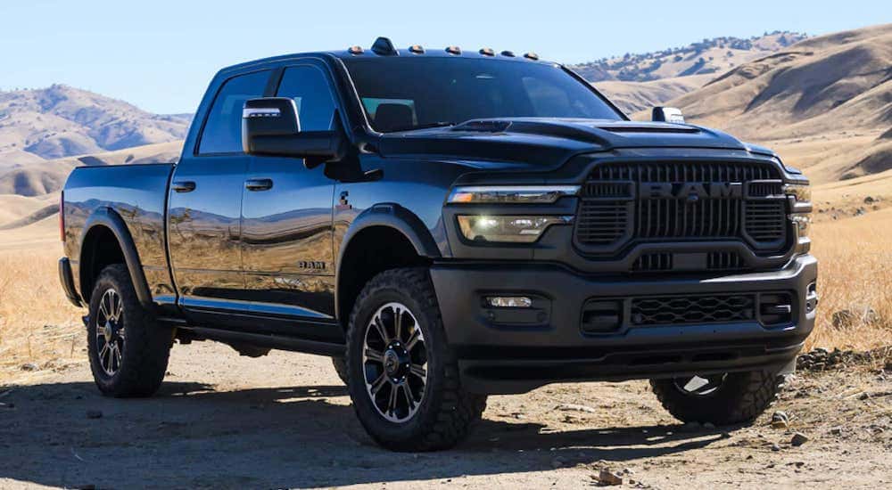 A black 2025 Ram 1500 parked in a desert.