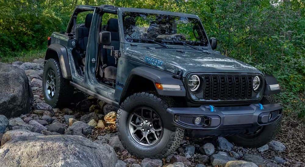 A gray 2025 Jeep Wrangler Willys for sale near Cincinnati parked off-road.