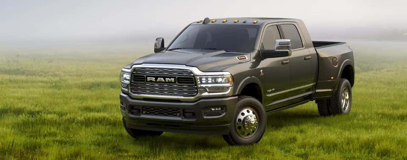 A grey 2023 Ram 3500 is parked on a foggy field.