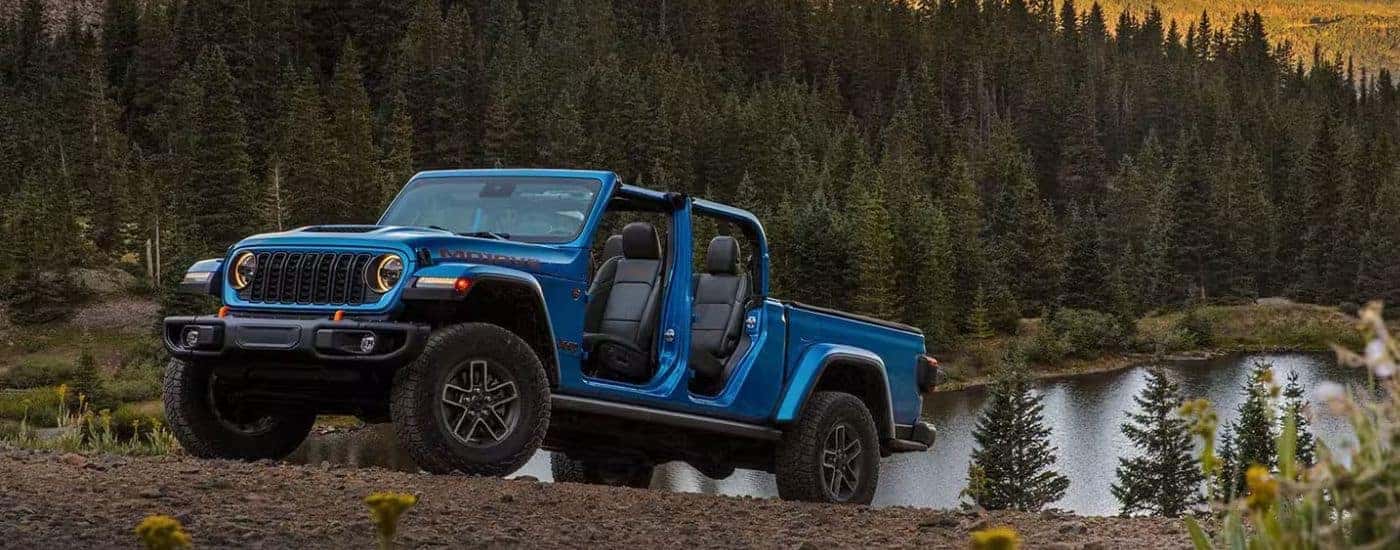 A blue 2025 Jeep Gladiator Mojave off-roading.