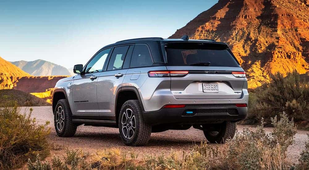 Rear view of a silver 2025 Jeep Grand Cherokee L parked off-road.