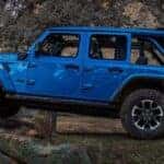 A blue 2025 Jeep Wrangler Rubicon off-roading