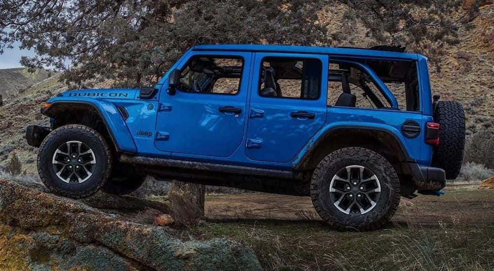 A blue 2025 Jeep Wrangler Rubicon off-roading