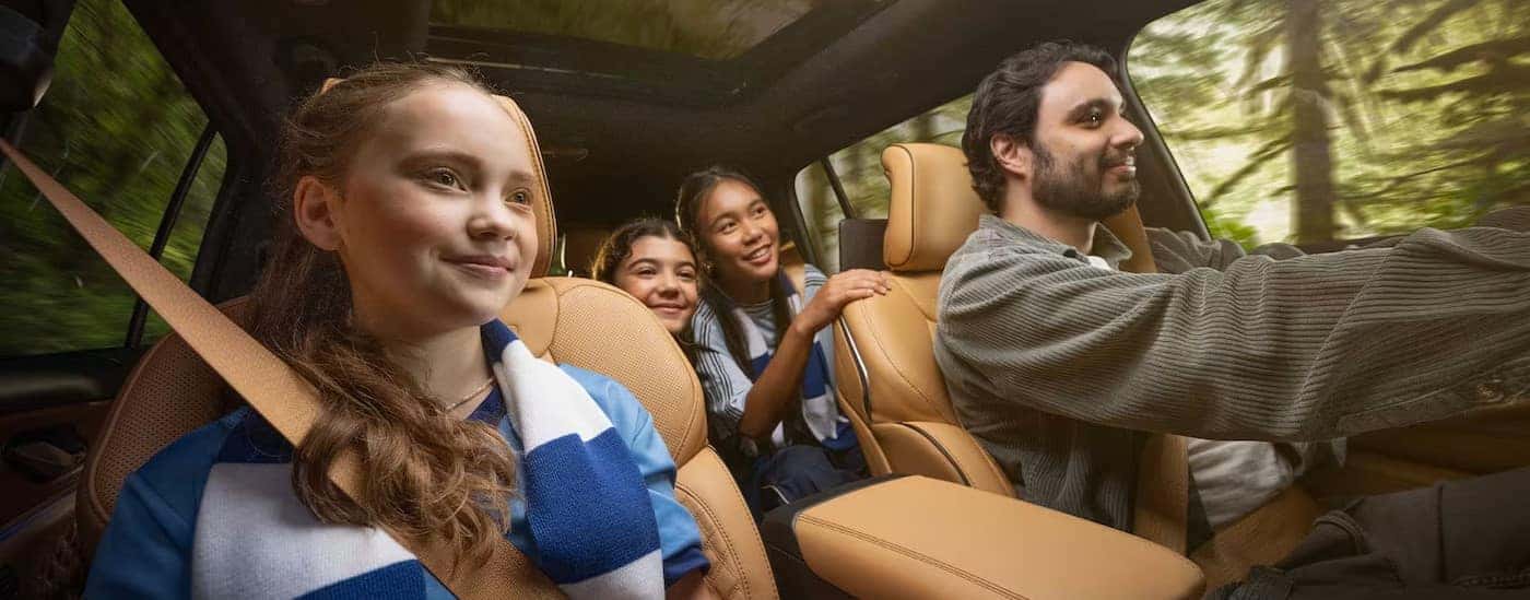 A family inside of a 2025 Jeep Grand Cherokee.