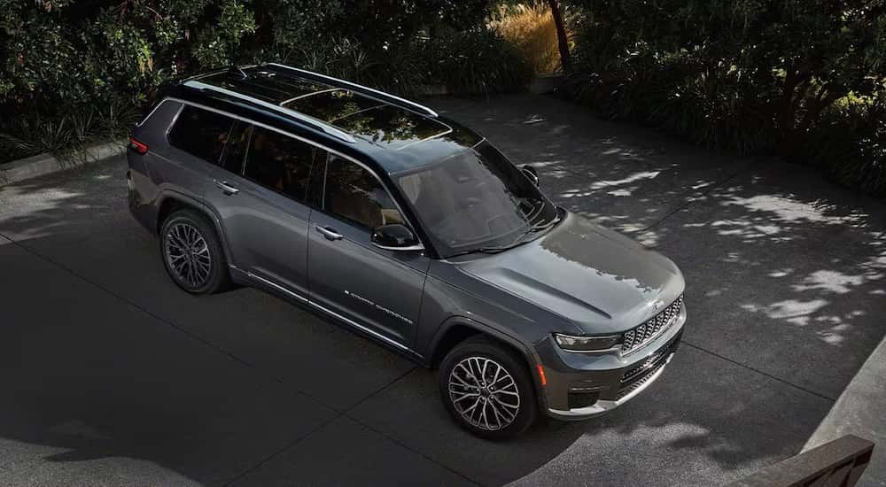 A grey 2025 Jeep Grand Cherokee L from the side at a high angle.