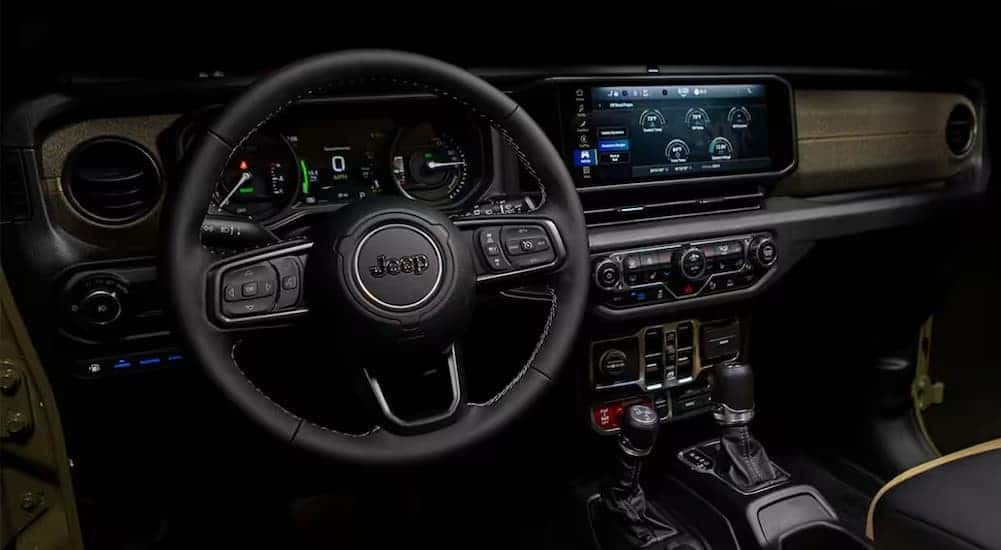 The black dash in a 2025 Jeep Wrangler for sale near Burlington.