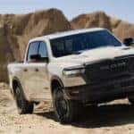 White 2025 Ram 1500 Rebel for sale near Covington driving through a desert.