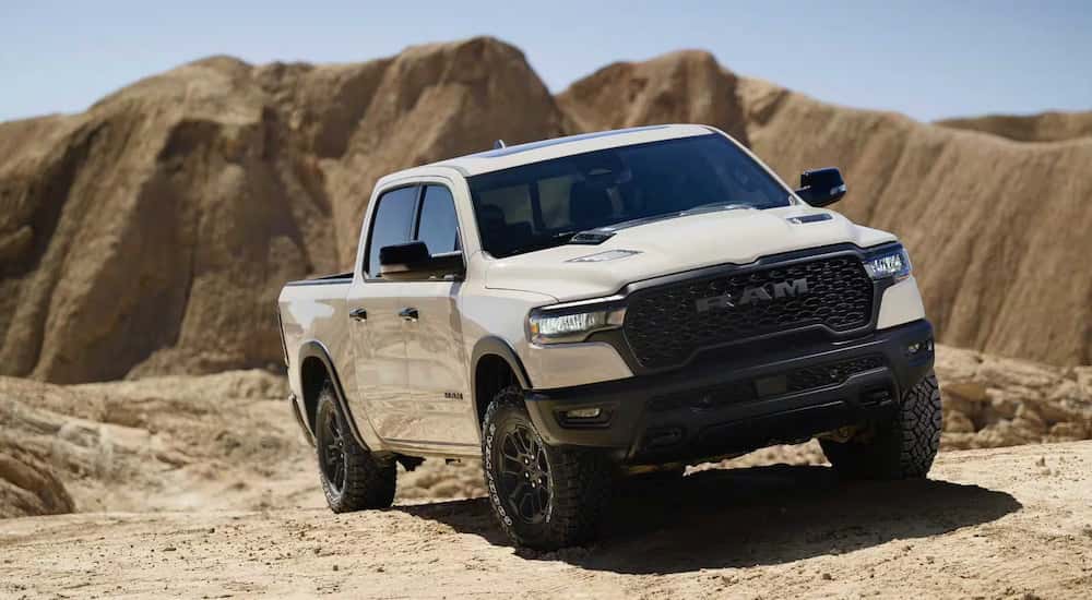 White 2025 Ram 1500 Rebel for sale near Covington driving through a desert.