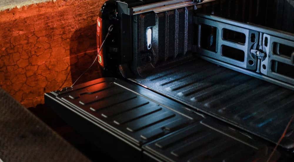 Open tailgate of a black 2025 Ram 1500.