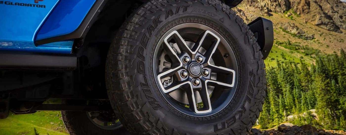 Rim and tire on a blue 2025 Jeep Gladiator.