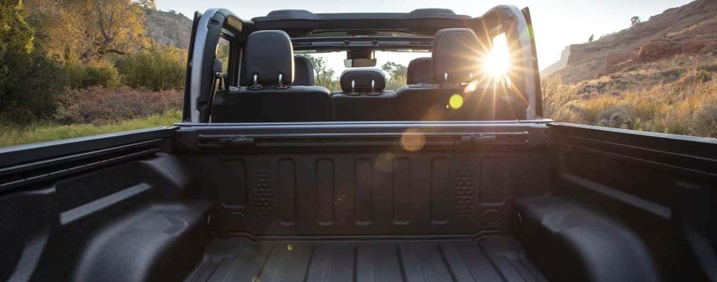 The bed of a silver 2023 Jeep Gladiator for sale near Burlington.