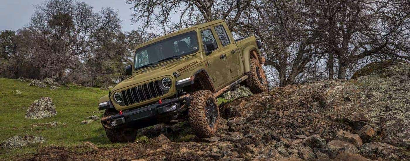 A green 2025 Jeep Gladiator Rubicon off-roading.