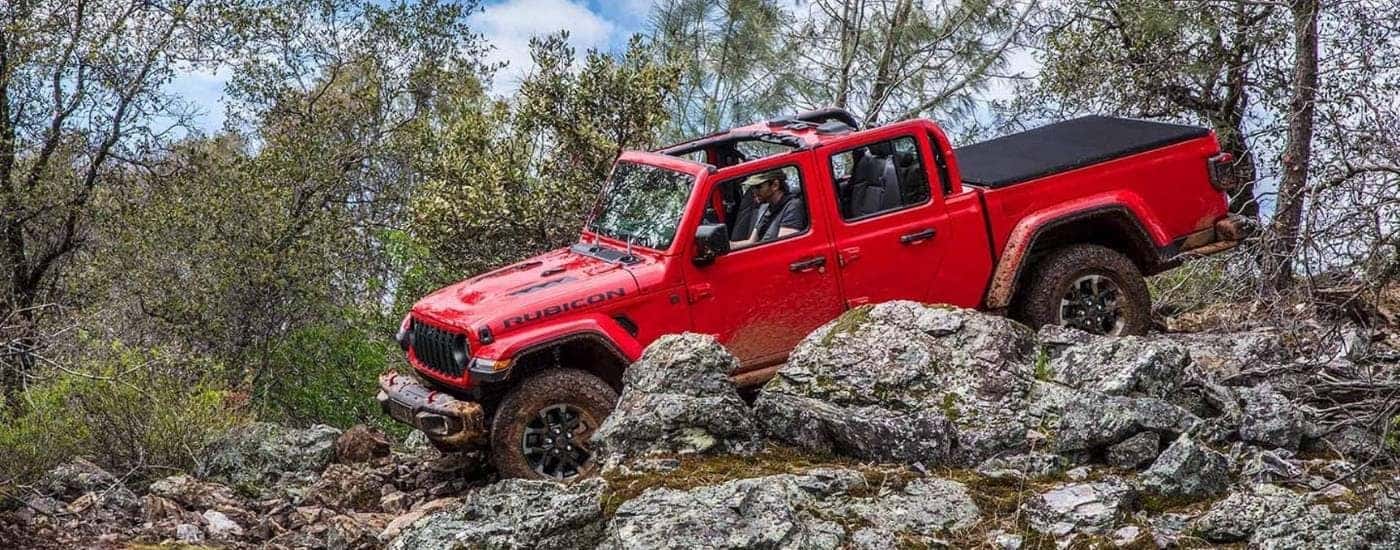A red 2024 Jeep Gladiator for sale near Cincinnati off-roading.