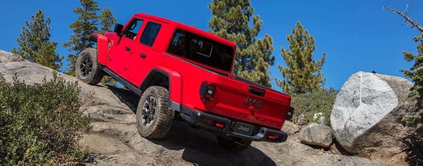 A red 2024 Jeep Gladiator for sale near Covington off-roading.