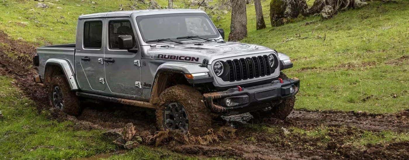 A grey 2024 Jeep Gladiator for sale in Florence off-roading.