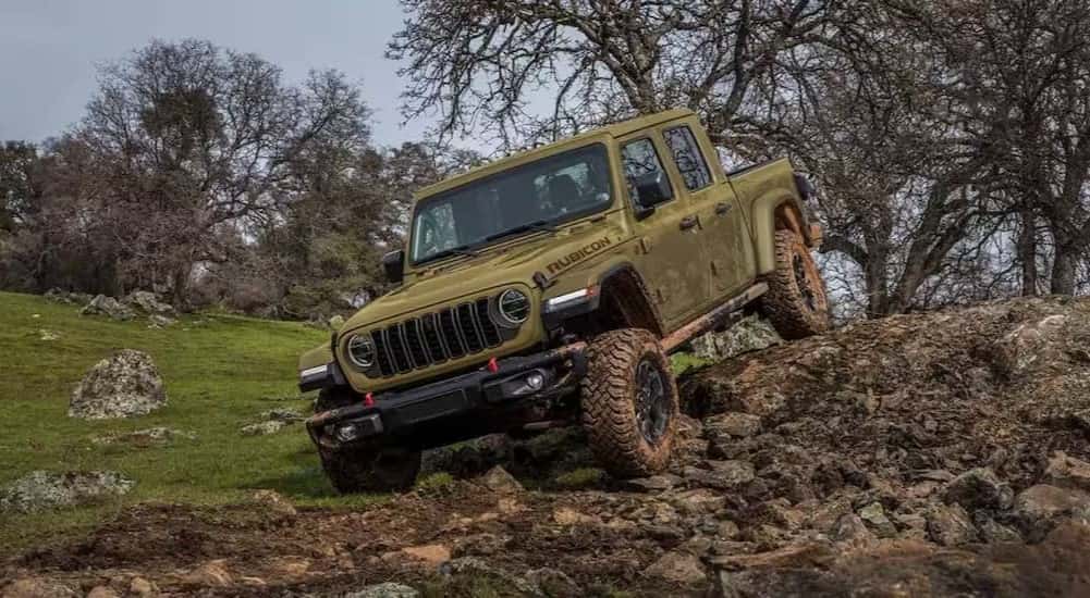 A green 2025 Jeep Gladiator Rubicon for sale off-roading.