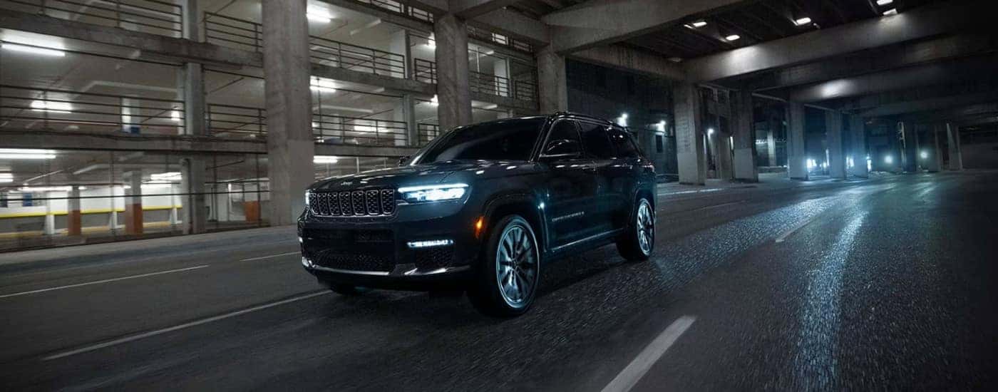 A black 2025 Jeep Grand Cherokee from the front at an angle.