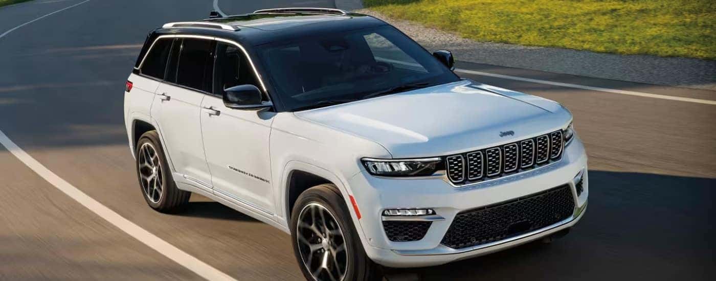A white 2024 Jeep Grand Cherokee from the front at an angle.