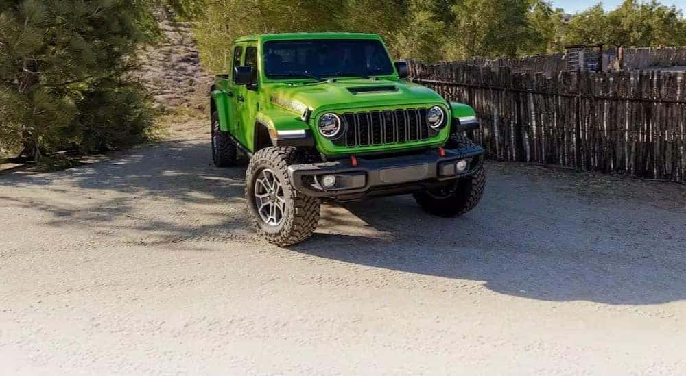 A green 2025 Jeep Gladiator Mojave parked off-road.