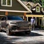 A dark gray 2025 Jeep Grand Cherokee for sale near Burlington parked in a driveway